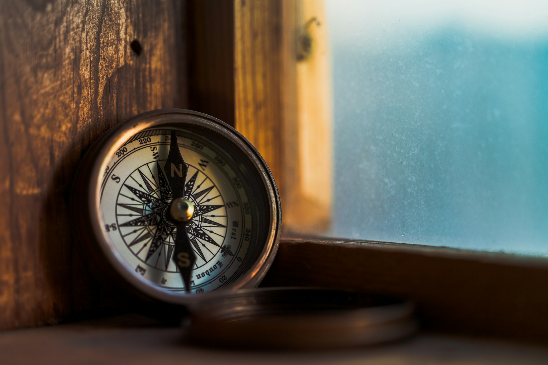 A compass beside a window, a place to take bearings