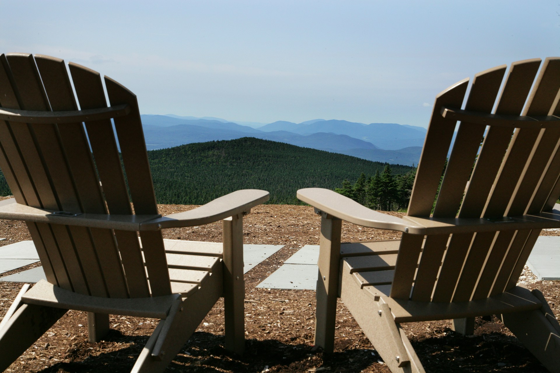 Two chairs looking over a mountain range